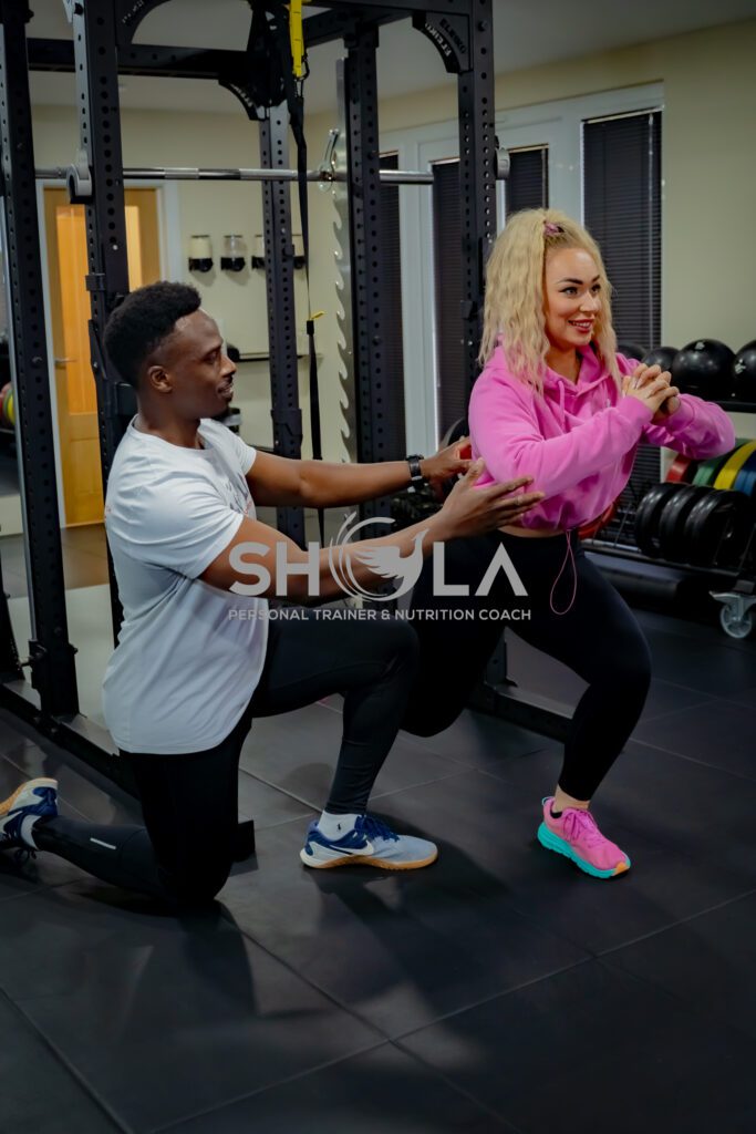 An image of Coach Shola one on one Personal training with a female client at The Private PT Studio