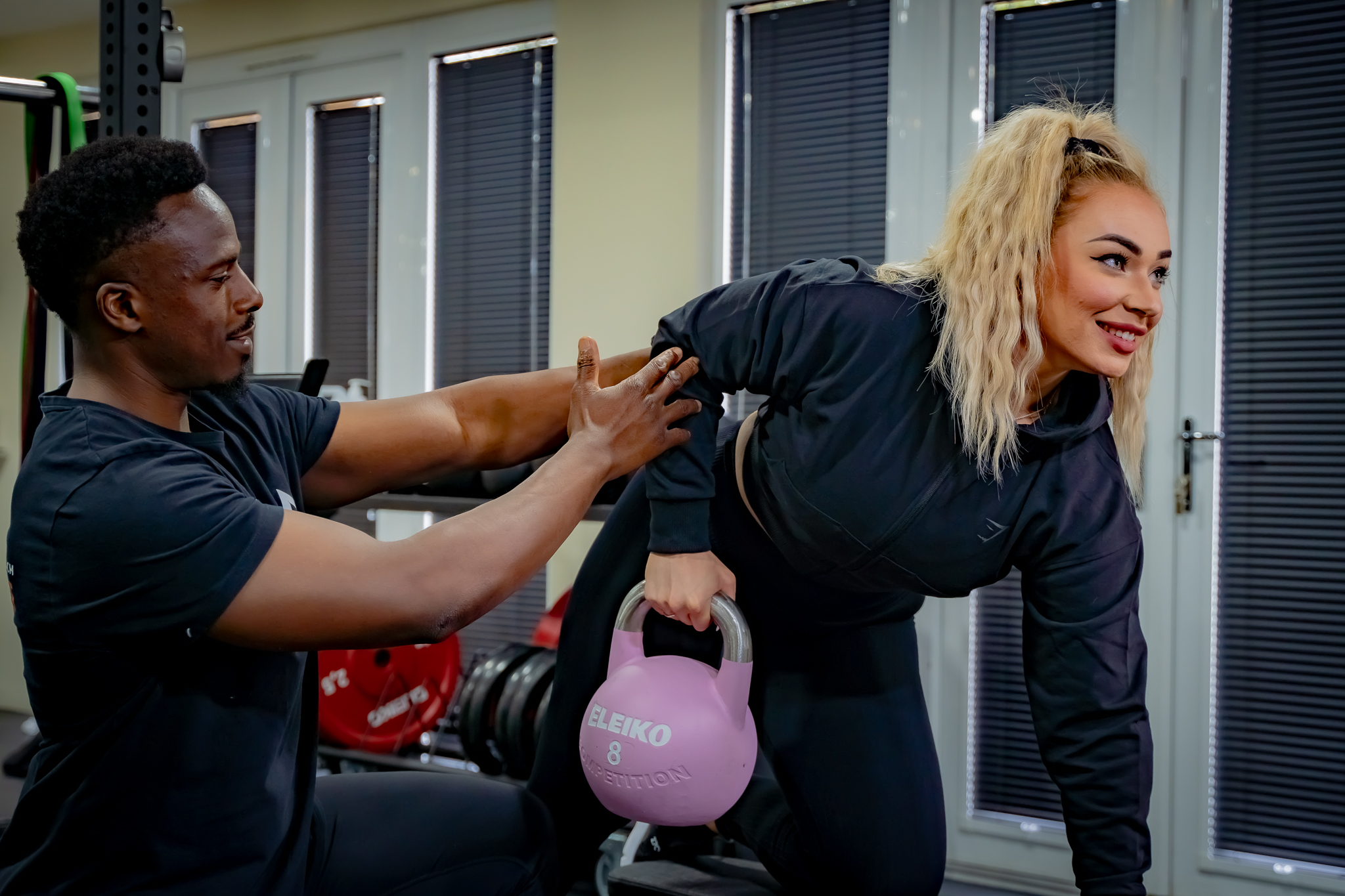 An image of a Personal trainer, training a female client. A Luxury Approach To Personal Training | Calcot, Reading, Berkshire