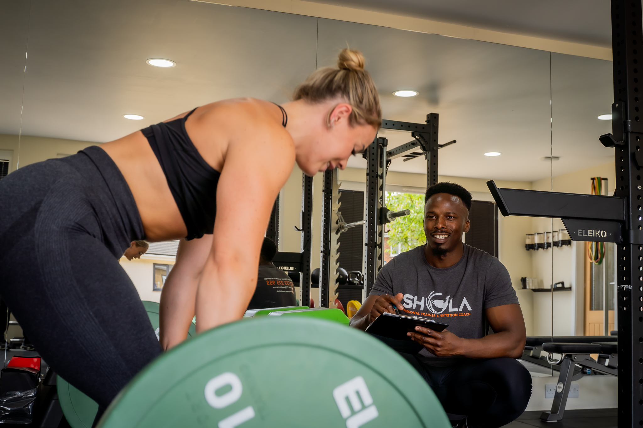 An image of Coach Shola doing a muscular strength, muscle endurance and power protocol test on a female client